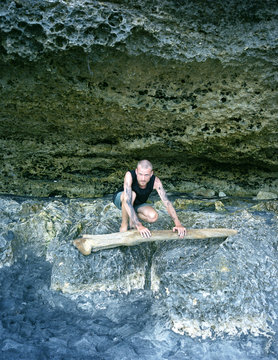 Young man in a cave on the beach