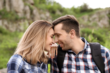 Young man with his girlfriend outdoors. Camping season