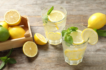 Glasses of natural lemonade with mint on table