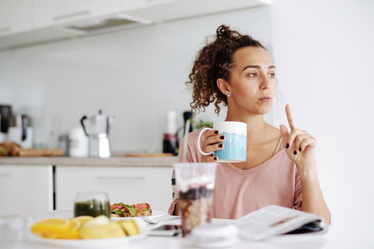 Pensive Young Woman At Breakfast