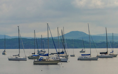 Mallets Bay on Lake Champlain, with many sailboats moored with the Green Mountains of Vermont...