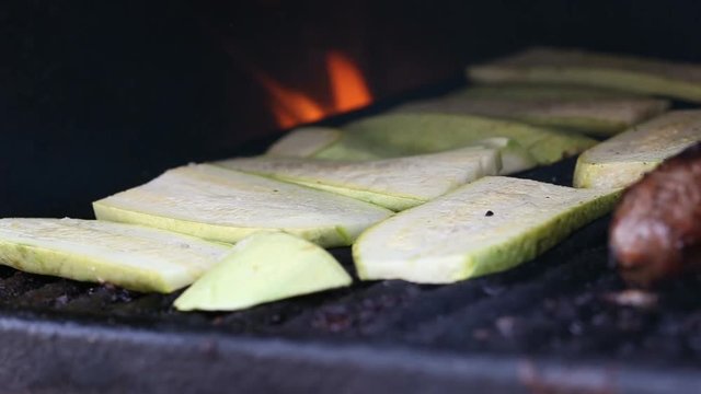 Grilling zucchinis on the barbecue in the summer season