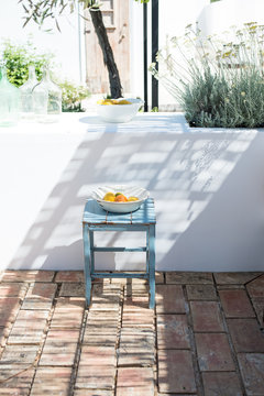 Blue bench with a portuguese porcelain font full of fruits in  typical mediterranean terrace