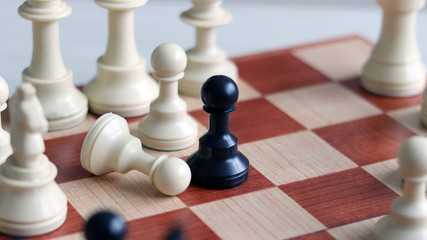 During a chess game, black pawn knocks down a white pawn.