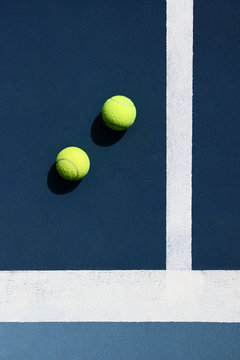 Two tennis balls on court