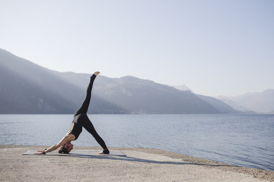 Woman doing One-Legged Down Dog, Eka Pada Adho Mukha Svanasana
