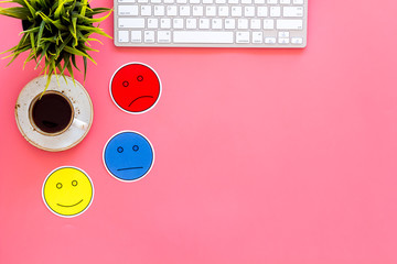 Customer satisfaction concept. Emoji smile, neutral, sad on work desk on pink background top view copy space
