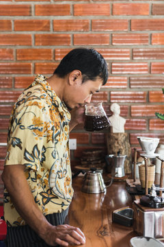 Asian barista making drip coffee