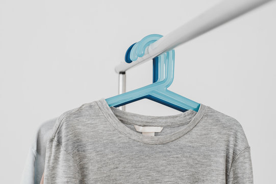 Grey long sleeve shirt on a hang