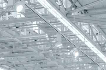 row of bright halogen spotlights on exhibition ceiling. industrial building interior