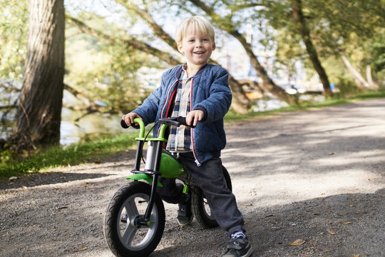 Excited toddler on his roller bike