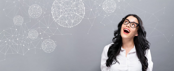 Technology Polygonal Spheres with happy young businesswoman on a gray background