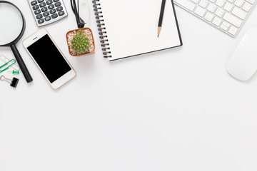 white office desk with copy space with smartphone, computer and office supplies top view