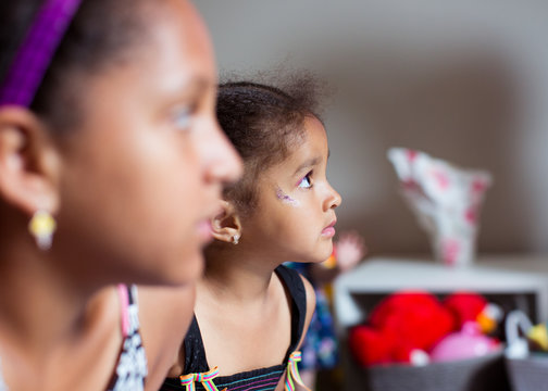 Portrait of two sister looking on attentively towards someone in the distance