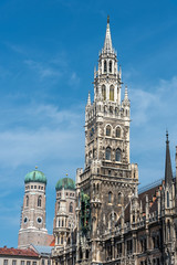 The towers of the New City Hall and the famous Frauenkirche at the Marienplatz in Munich on a sunny day