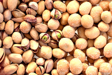 Snack in beer. Pistachio nuts and peanuts (peanuts) in a crisp frosting. The taste of horse-radish. Close-up, Selective focus. A place to copy. View from above.