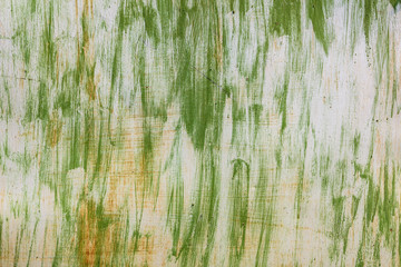 Metal texture with scratches, cracks and rust. Traces of green paint