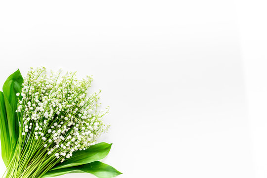 May flowers. Bouqet of lily of the valley flowers on white background top view copy space