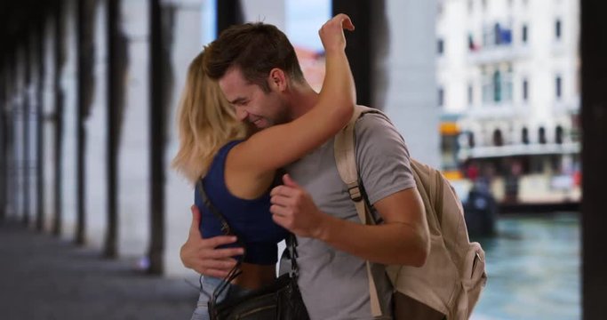Happy and attractive couple on holiday in Venice, Portrait of playful couple being affectionate outdoors, 4k