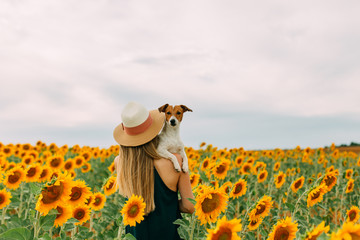 Caucasian woman enjoying summer time at sunflowers field