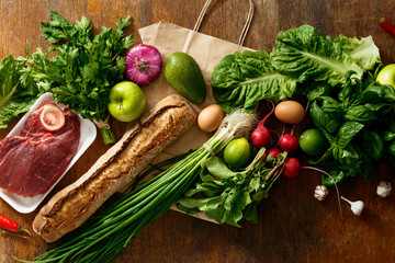 Paper bag set healthy food dark background