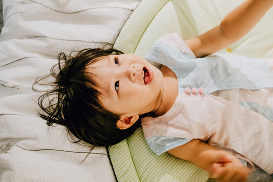 Asian little girl on bed