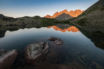 Mountain peaks reflected in water