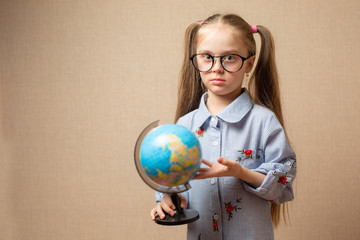 little girl holding the earth in our hands - a concept about the future