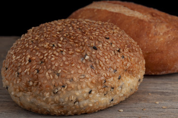Close-up of bread sprinkle sesame on old wooden background,healthy food concept