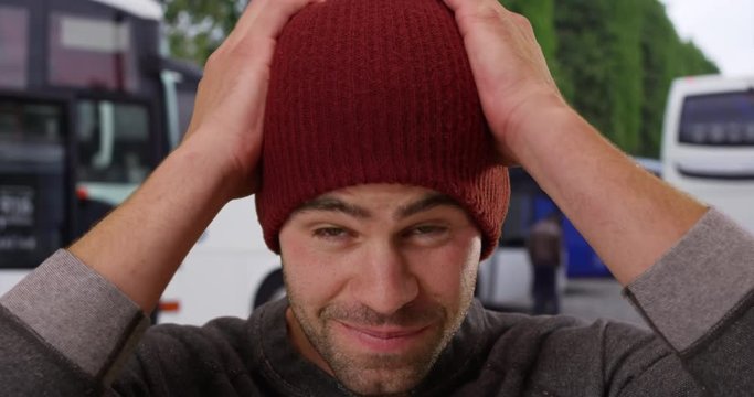 Close up portrait of sexy Caucasian man outdoors, Cool and handsome guy wearing a beanie smiles at camera, 4k