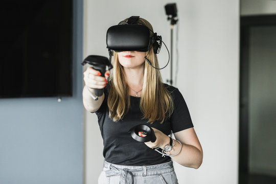 Blond girl playing VR game