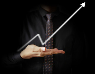 Businessman with financial symbols coming