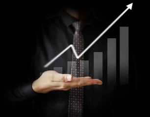 Businessman with financial symbols coming