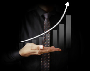 Businessman with financial symbols coming