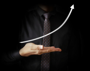 Businessman with financial symbols coming