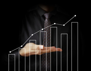 Businessman with financial symbols coming