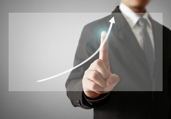 Businessman with financial symbols coming