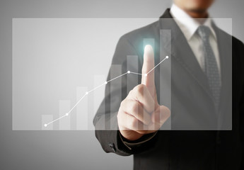 Businessman with financial symbols coming