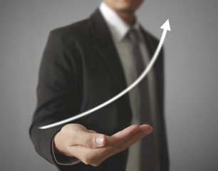 Businessman with financial symbols coming