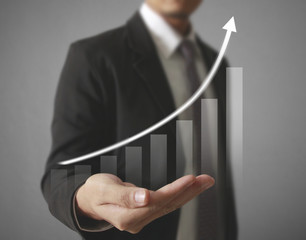Businessman with financial symbols coming