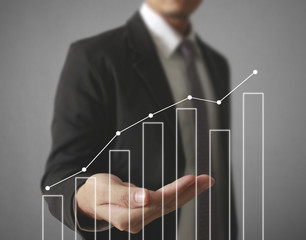 Businessman with financial symbols coming