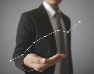 Businessman with financial symbols coming