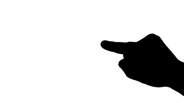 The finger of a female hand pointing at something. Silhouette shot.
