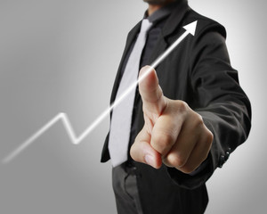 Businessman with financial symbols coming