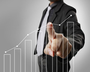 Businessman with financial symbols coming