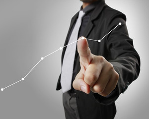 Businessman with financial symbols coming