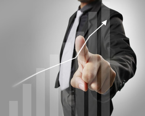 Businessman with financial symbols coming