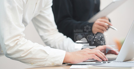 close up businessman hand type on laptop with infographic display for consult stock statistic graph with businesswoman for business technology concept