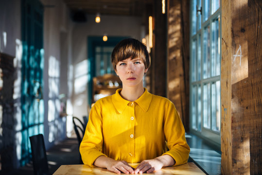 Portrait of young woman dressed in yellow