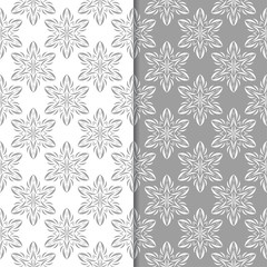 Fototapeta premium White and gray floral backgrounds. Set of seamless patterns